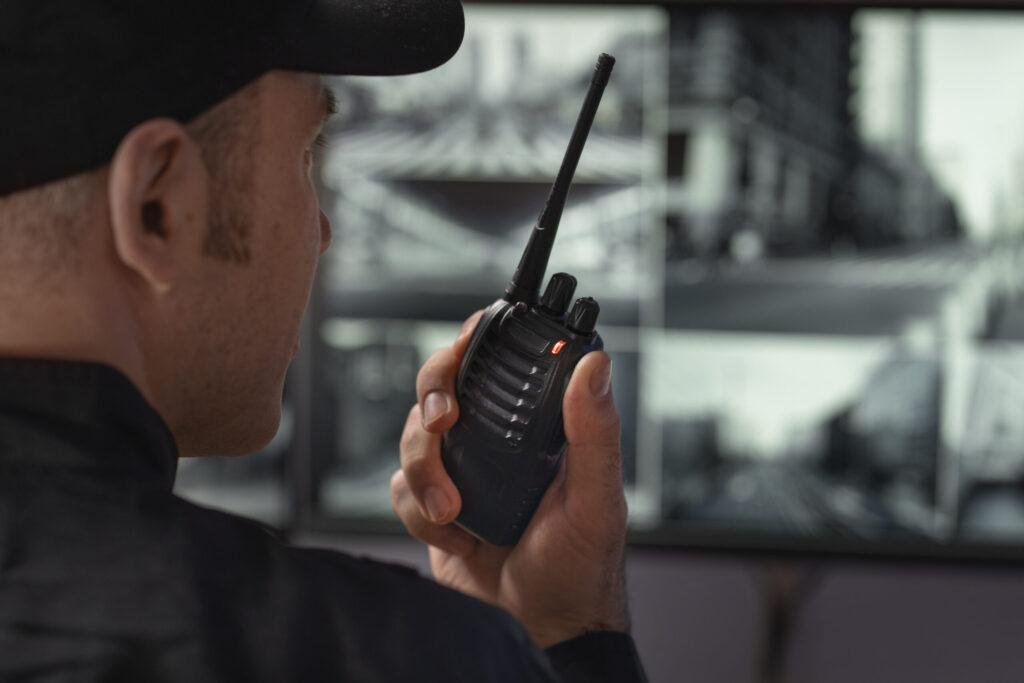 portrait_male_security_guard_with_radio_station_camera_screens